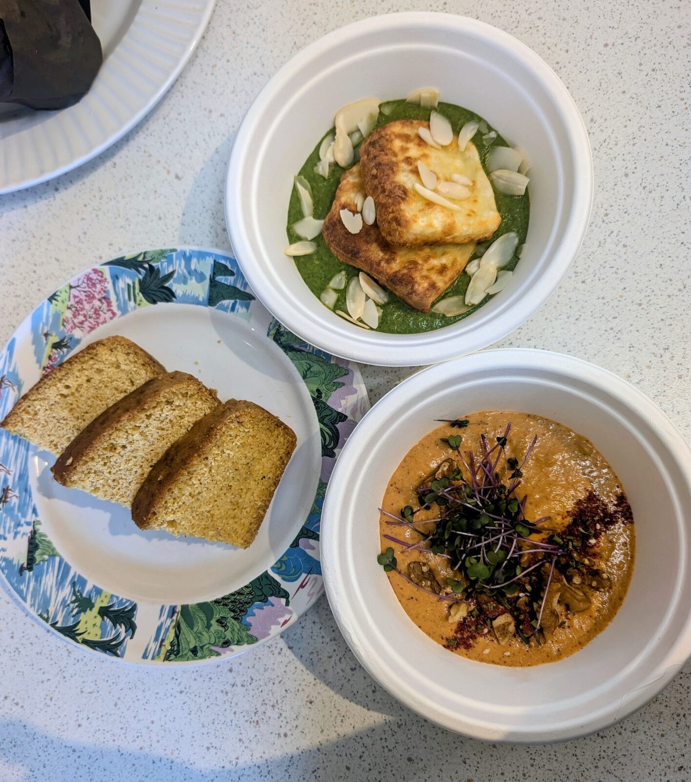 Gluten-free baked halloumi over green pesto, fresh-baked cornbread, and creamy carrot-walnut soup