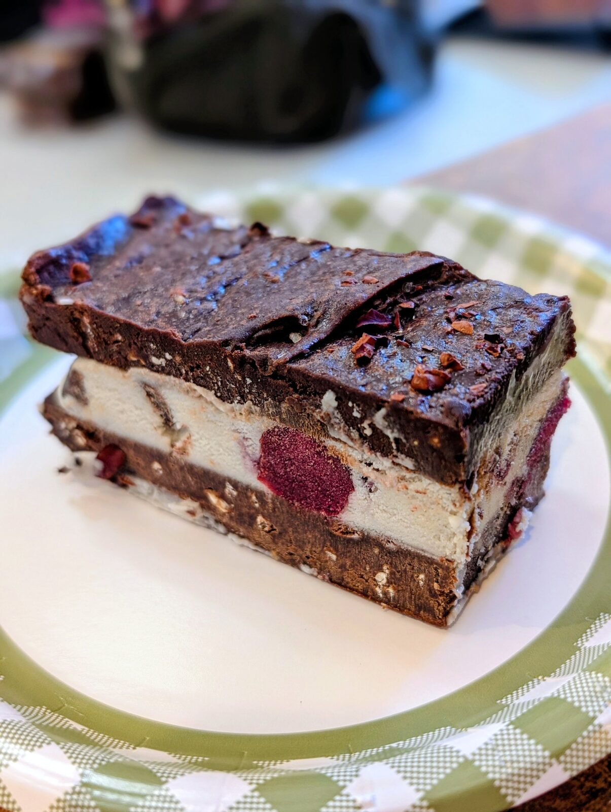 Raw chocolate raspberry layered bar with cocoa nibs and rose petals