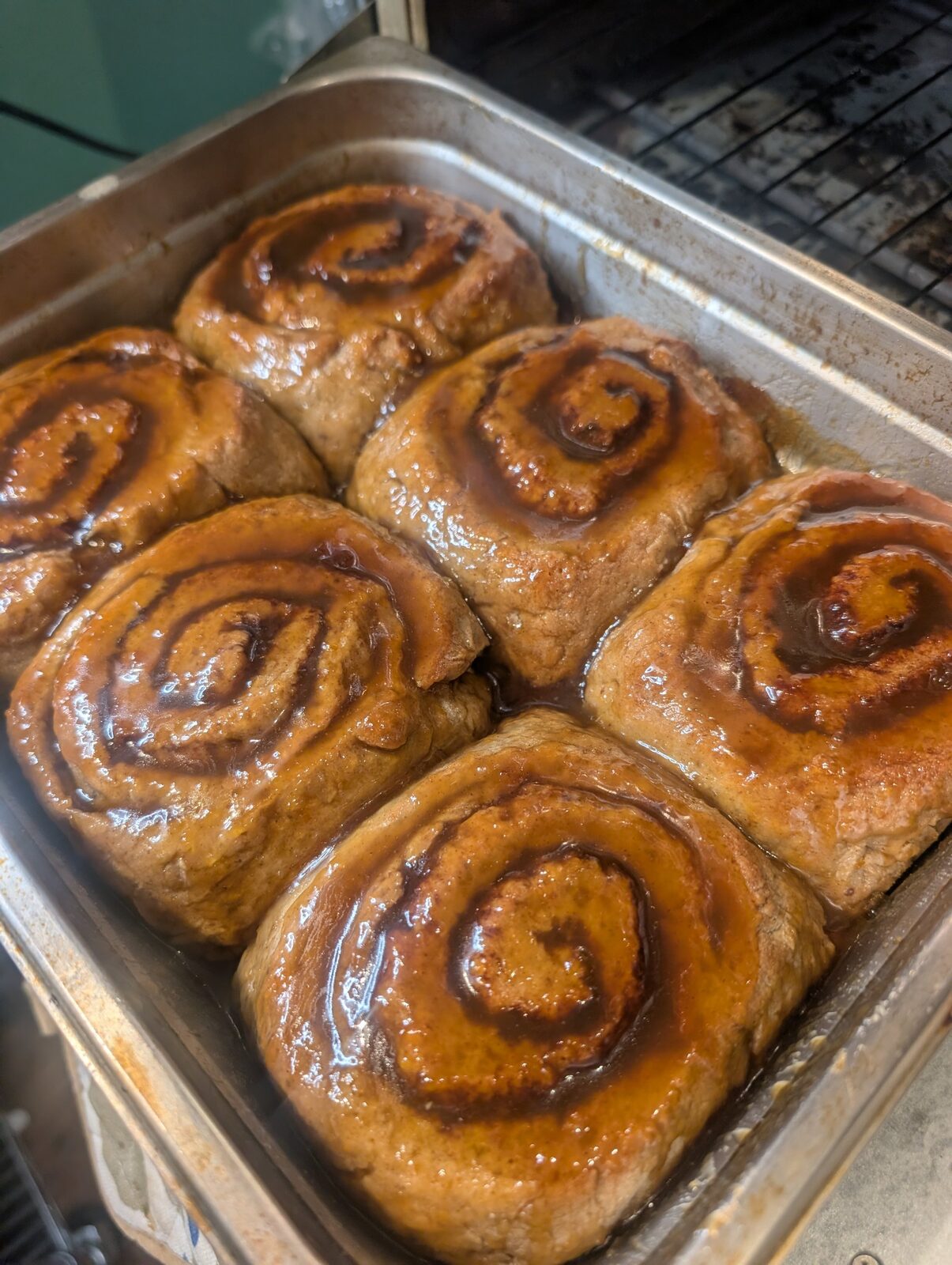 Pan of fresh-baked gluten-free cinnamon rolls with caramel glaze