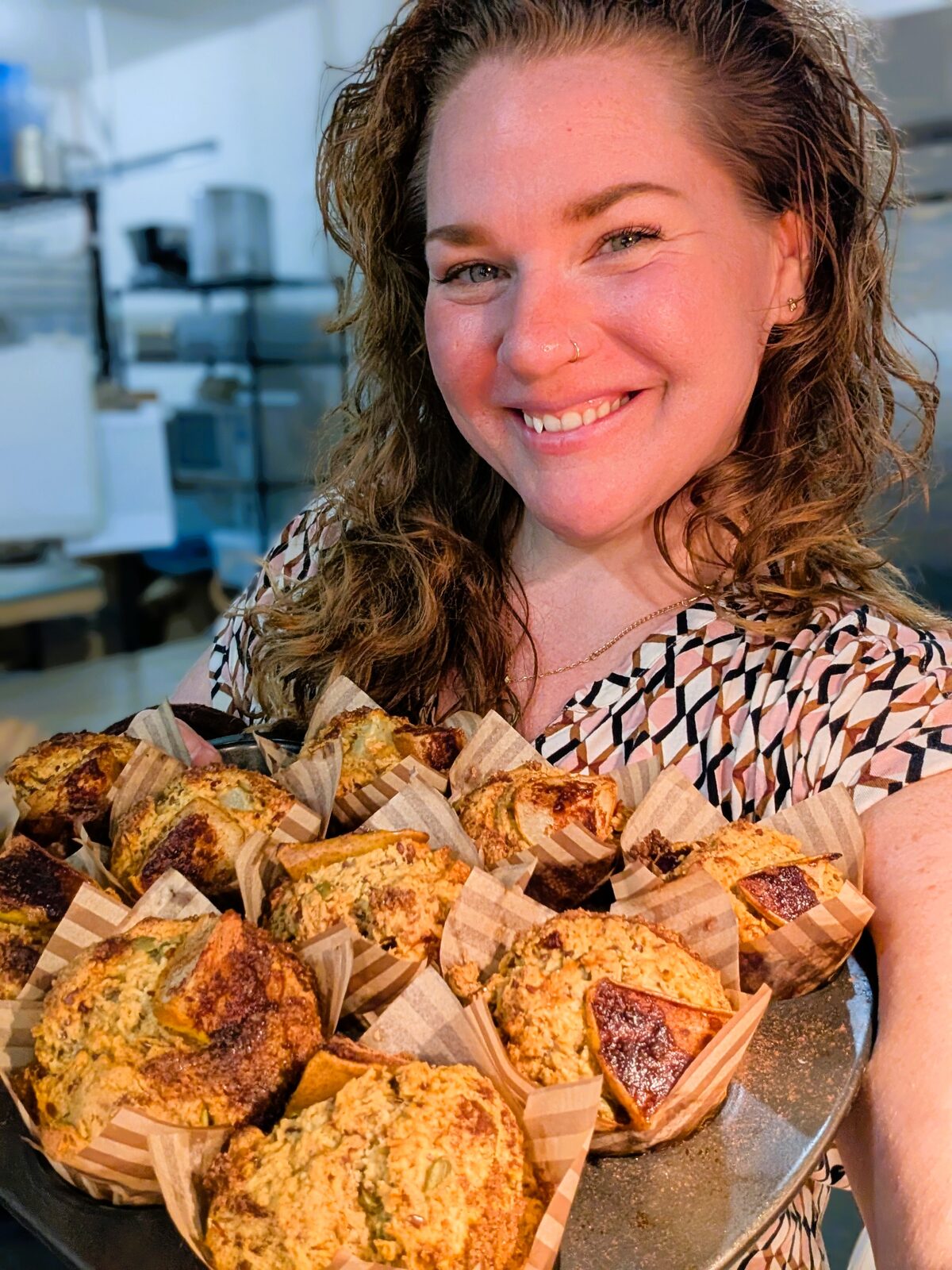 Chef Colleen holding a tray of fresh-baked muffins
