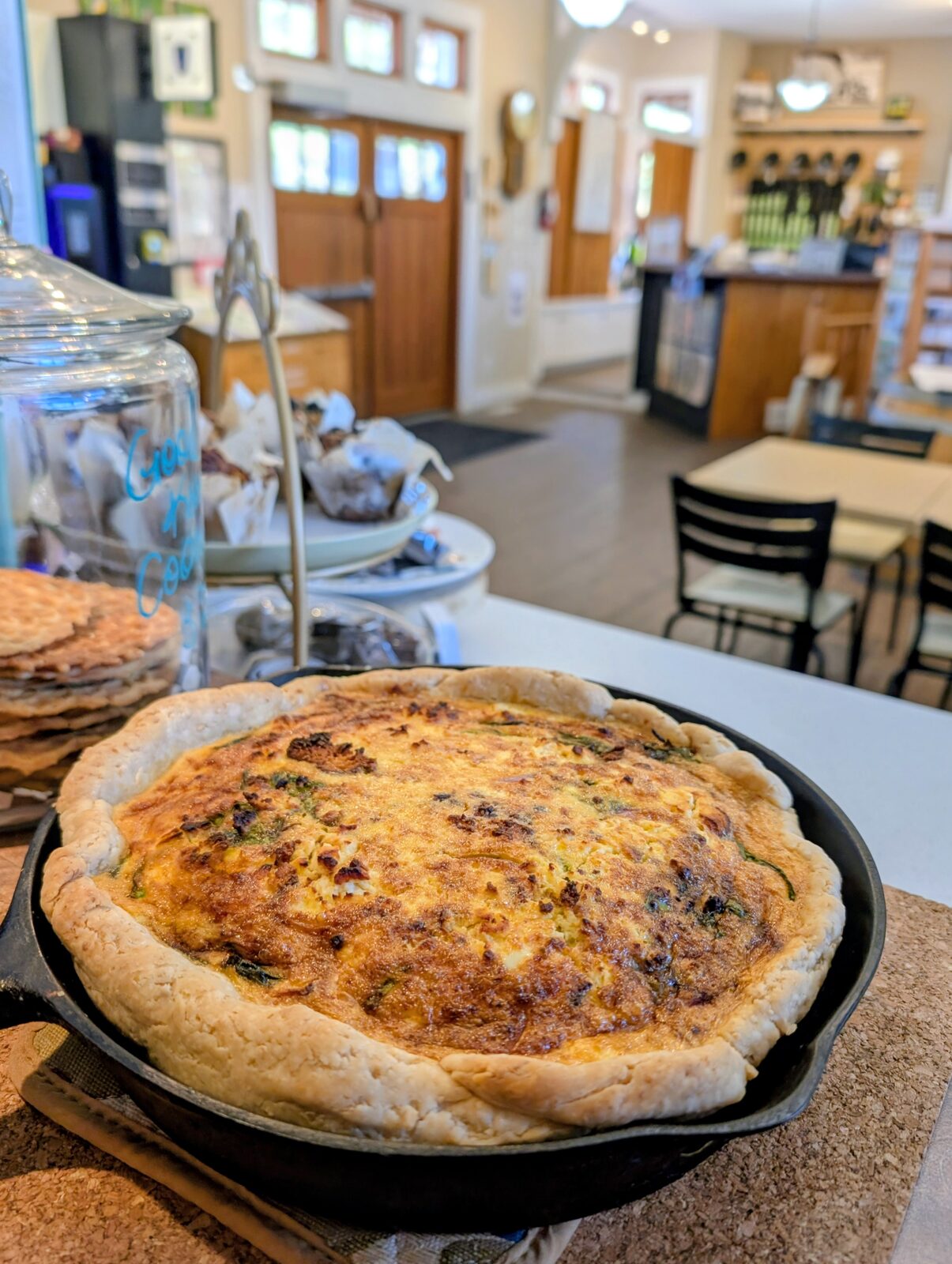 Fresh-baked quiche in a cast iron pan inside the shop