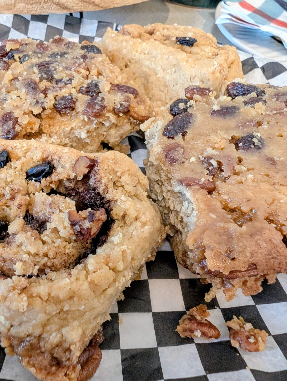 Close-up of cinnamon scones with raisins on checkered paper